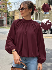 Mock-neck shirt with tie detail and tulip hem