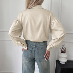 Lantern-sleeve shirt with a stand collar and contrasting piping.