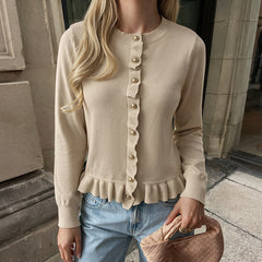 Solid-color crew-neck sweater with lettuce-edge trim and button detailing