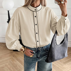 Lantern-sleeve shirt with a stand collar and contrasting piping.